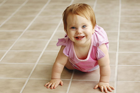 Child crawling on tile