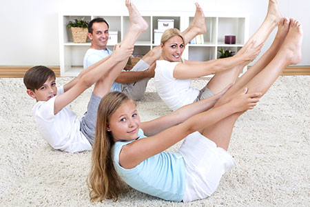 Family exercising on carpet